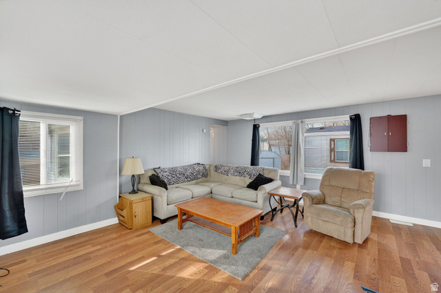 24 Grover Street Layton, UT 84041 - Photo 12 of 21 Living room featuring wood finished floors and wood walls