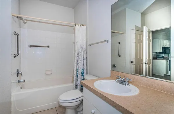 a bathroom with a sink toilet tub and shower
