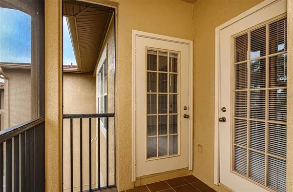 a view of a balcony with a floor to ceiling window and wooden fence