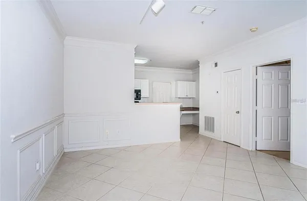 a view of a kitchen with white cabinets