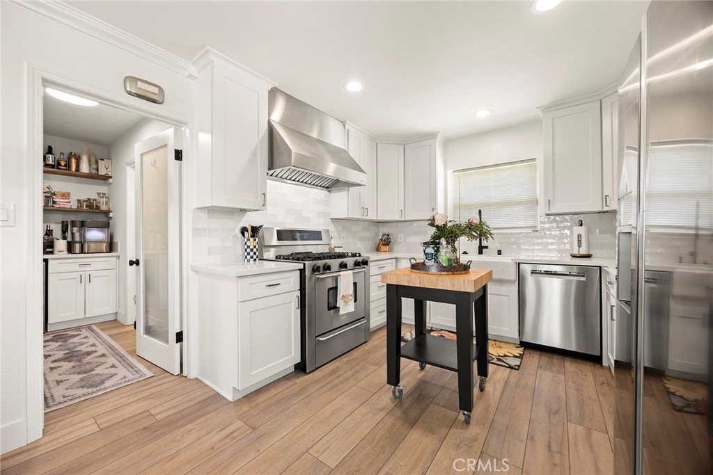 15914 West Road Whittier, CA 90603 - Photo 18 of 47 a kitchen with white cabinets and white appliances