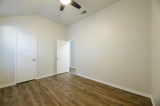 an empty room with a empty space and a ceiling fan