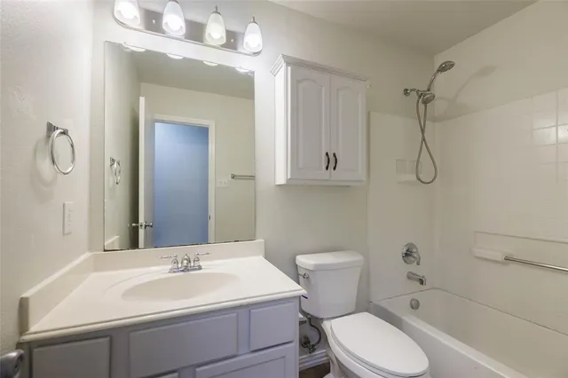 a bathroom with a toilet sink shower and mirror