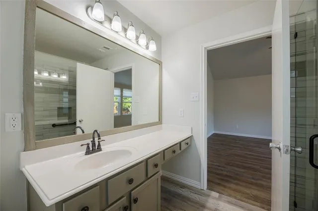 a bathroom with a sink double vanity and a mirror