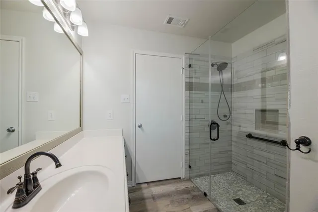 a bathroom with a sink and shower