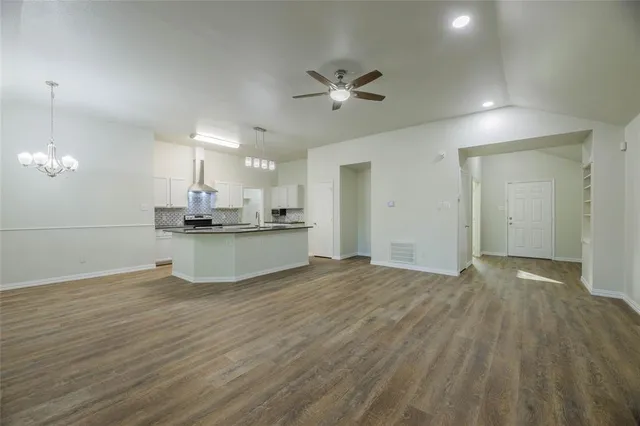 a view of a kitchen with a sink and wooden floor