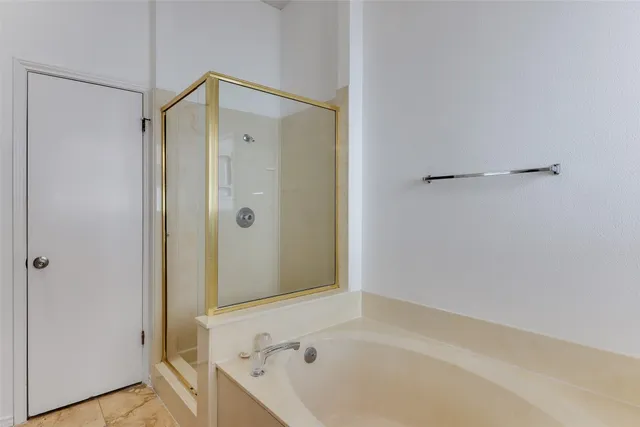 a bathroom with a bathtub and a shower