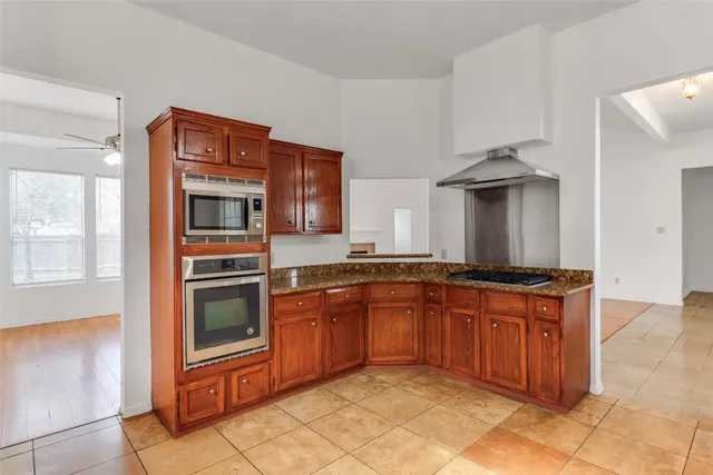 a kitchen with stainless steel appliances granite countertop a stove and a sink
