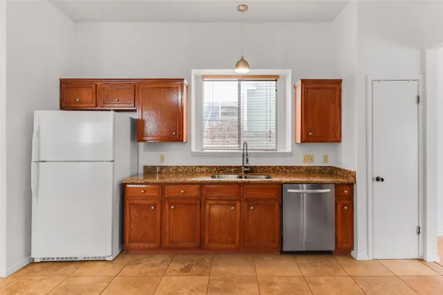 a kitchen with stainless steel appliances granite countertop a refrigerator and a sink