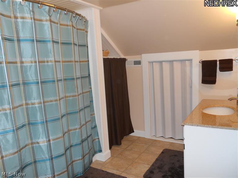 17540 Kinsman Road Middlefield, OH 44062 - Photo 12 of 16 Freshly updated 2 floor bath with tub surround, built in linen closets, granite vanity and loads of storage.