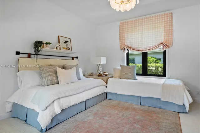 a bedroom with bed and window