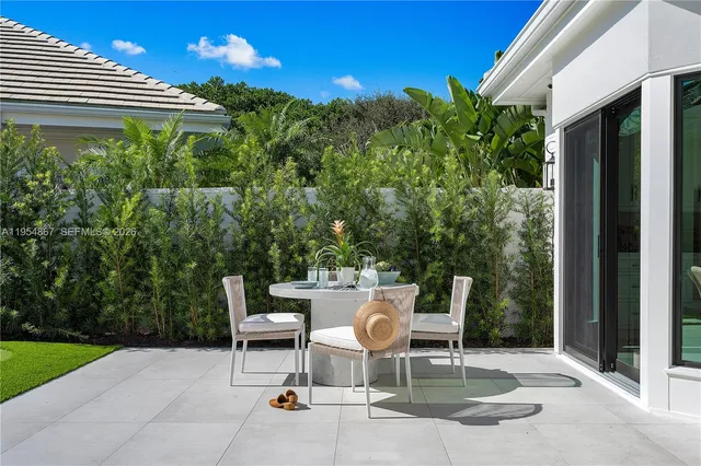 a view of a chair and tables in the backyard of the house