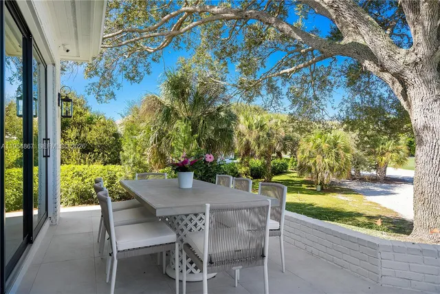 a view of an outdoor dining space with a table and chairs