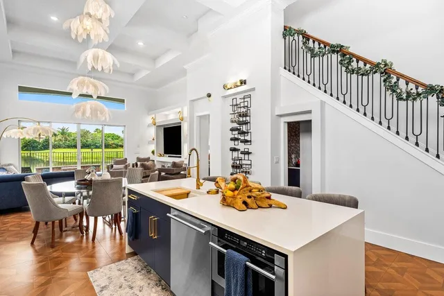 a view of a dining room with furniture a chandelier and wooden floor