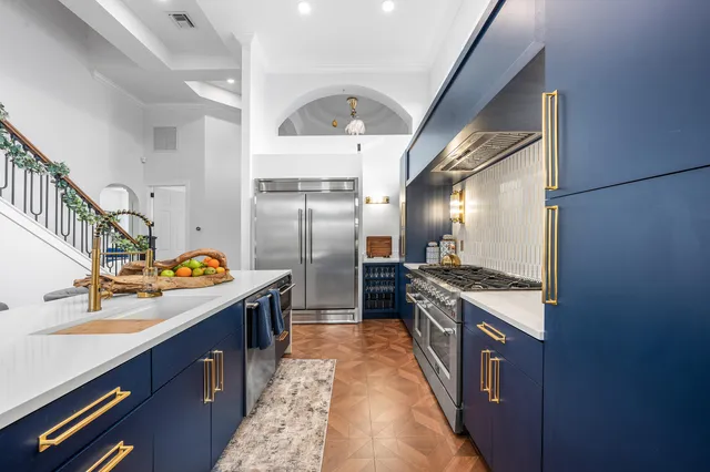 a kitchen with stainless steel appliances granite countertop a stove and a refrigerator
