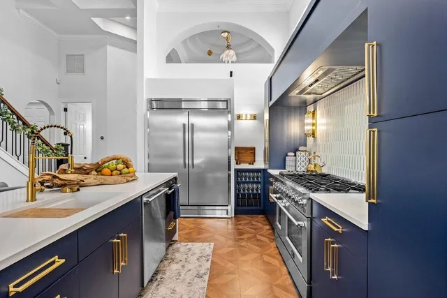 a kitchen with stainless steel appliances granite countertop a sink stove and refrigerator