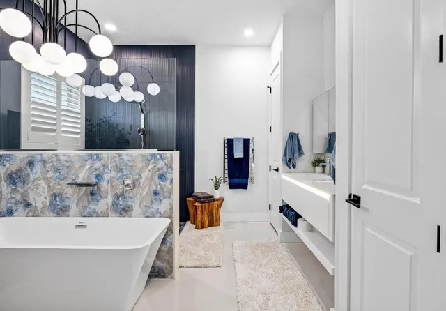 a bathroom with a bathtub and a chandelier