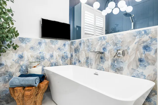 a bathroom with a bathtub and a mirror