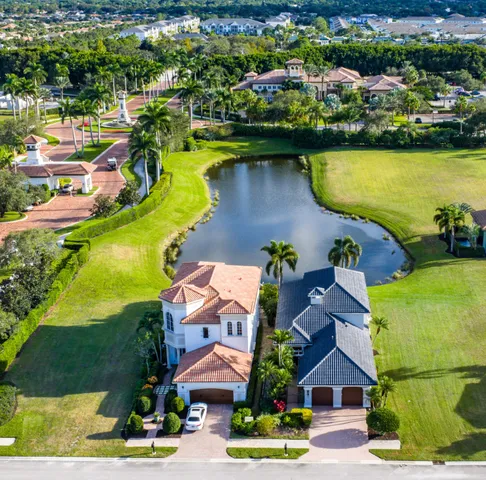 an aerial view of residential houses with outdoor space and lake view
