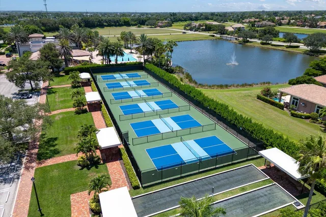 an aerial view of a house with a garden and lake view