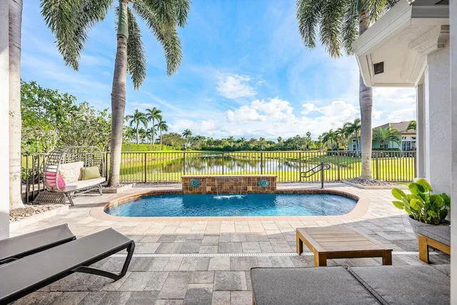 a view of swimming pool with outdoor seating and a yard