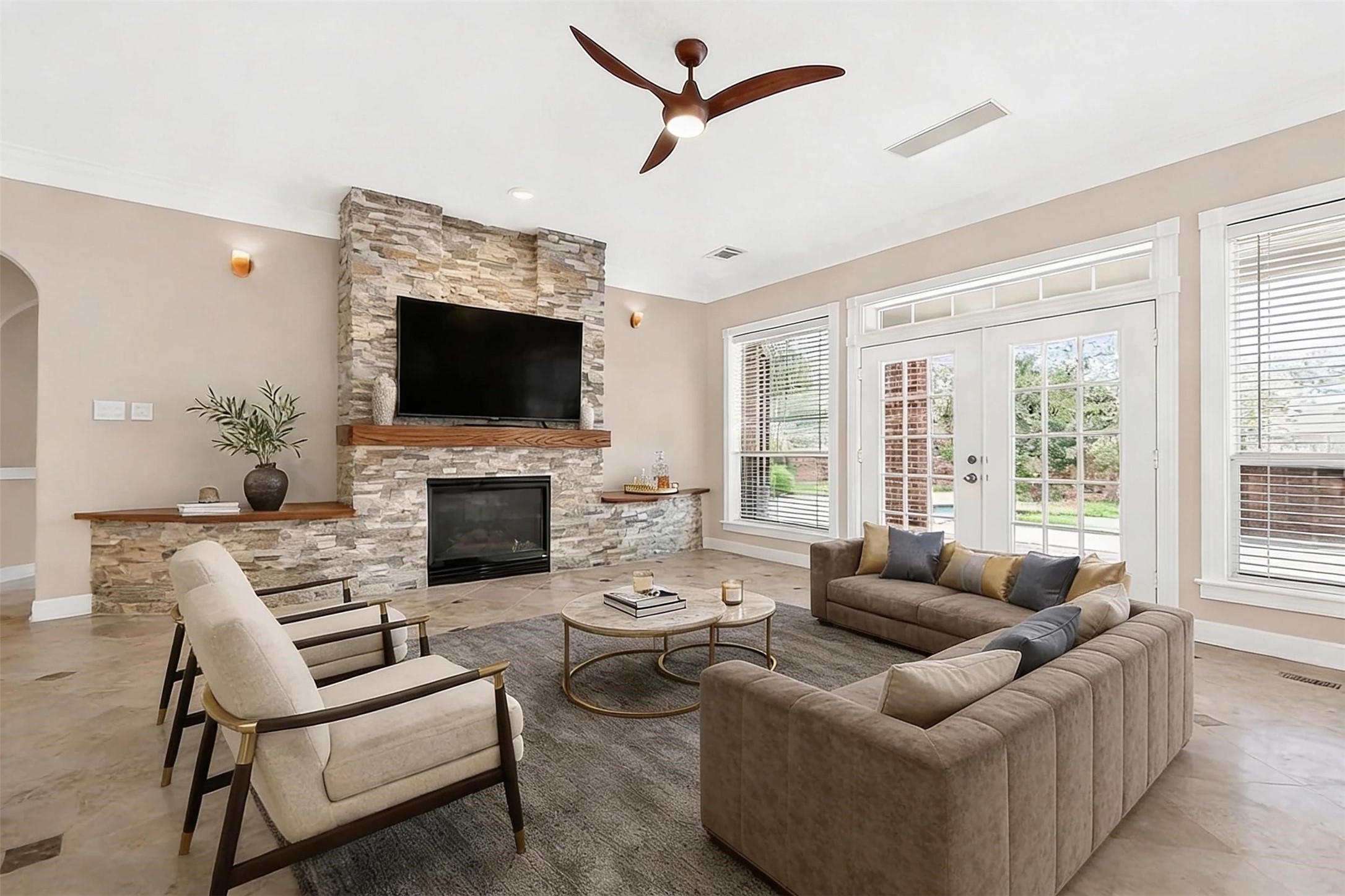 4203 Deforest Ridge Circle Katy, TX 77494 - Photo 14 of 50 Light and bright family room with stacked stone fireplace as a focal point. Awesome views overlooking the covered back patio and pool. Flanking the fireplace are cleverly disguised storages! (virtually staged)