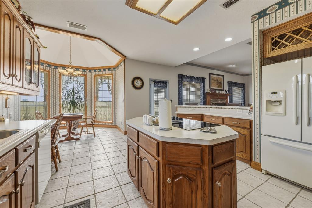 130 Blazek Road Alma, TX 75119 - Photo 13 of 34 a dining hall with stainless steel appliances granite countertop a sink and a refrigerator