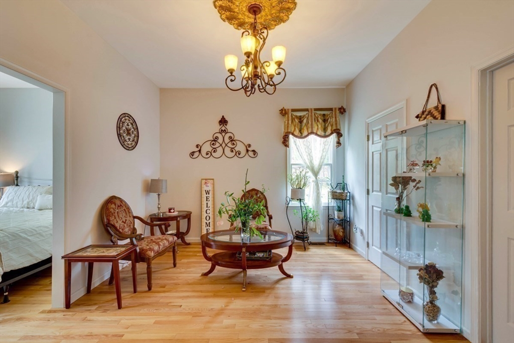22 Robert Road Marlborough, MA 01752 - Photo 19 of 42 a living room with furniture chandelier and a window