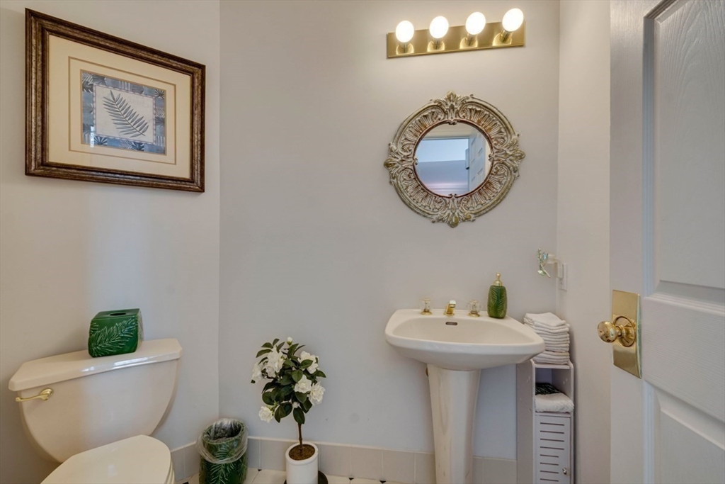 22 Robert Road Marlborough, MA 01752 - Photo 21 of 42 a bathroom with a toilet a sink and a mirror