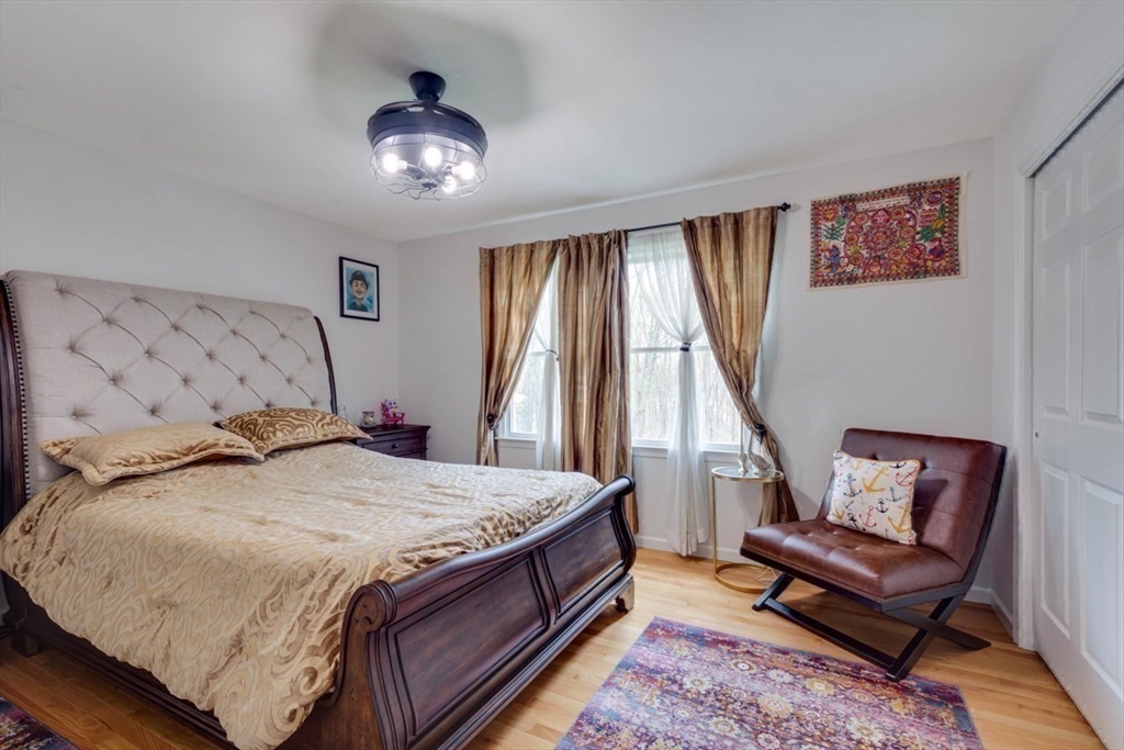 22 Robert Road Marlborough, MA 01752 - Photo 28 of 42 a bedroom with a bed and a chandelier