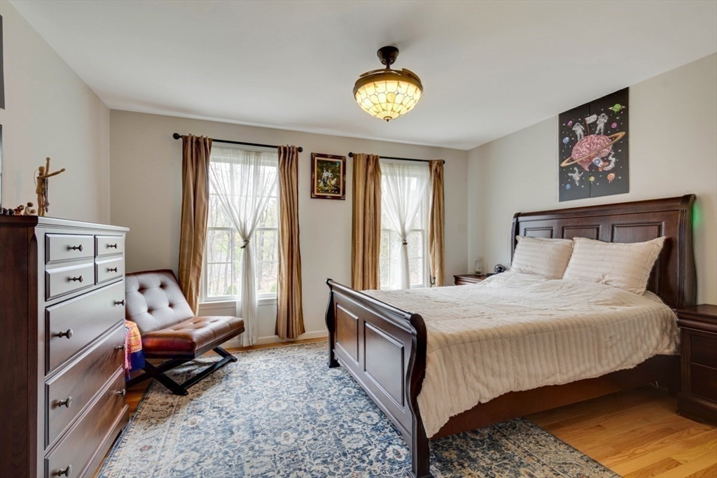 22 Robert Road Marlborough, MA 01752 - Photo 29 of 42 a bedroom with a bed and wooden floor