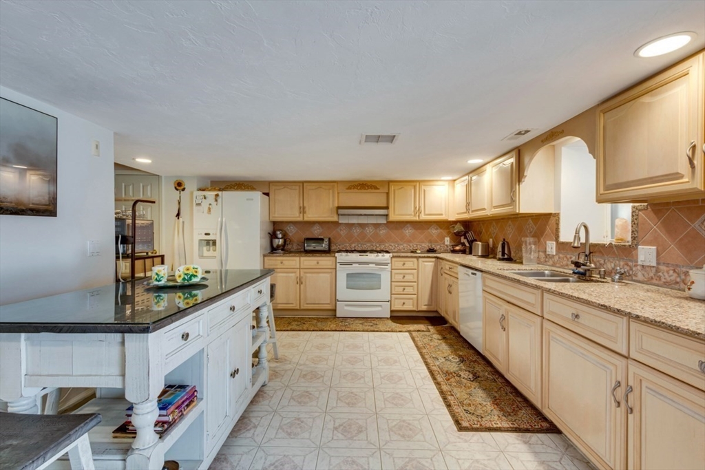 22 Robert Road Marlborough, MA 01752 - Photo 34 of 42 a kitchen with white cabinets and white appliances