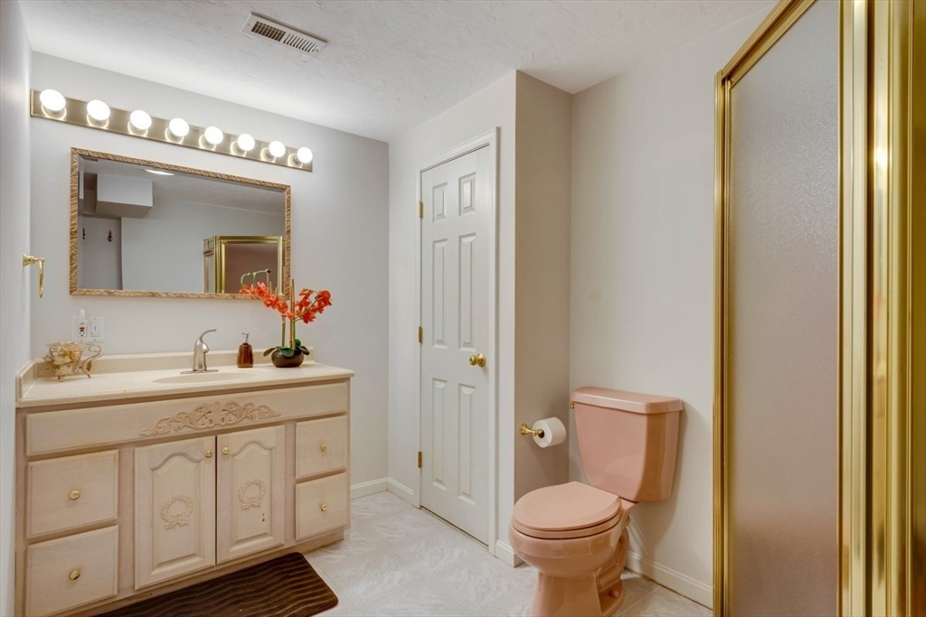 22 Robert Road Marlborough, MA 01752 - Photo 35 of 42 a bathroom with a toilet sink and mirror