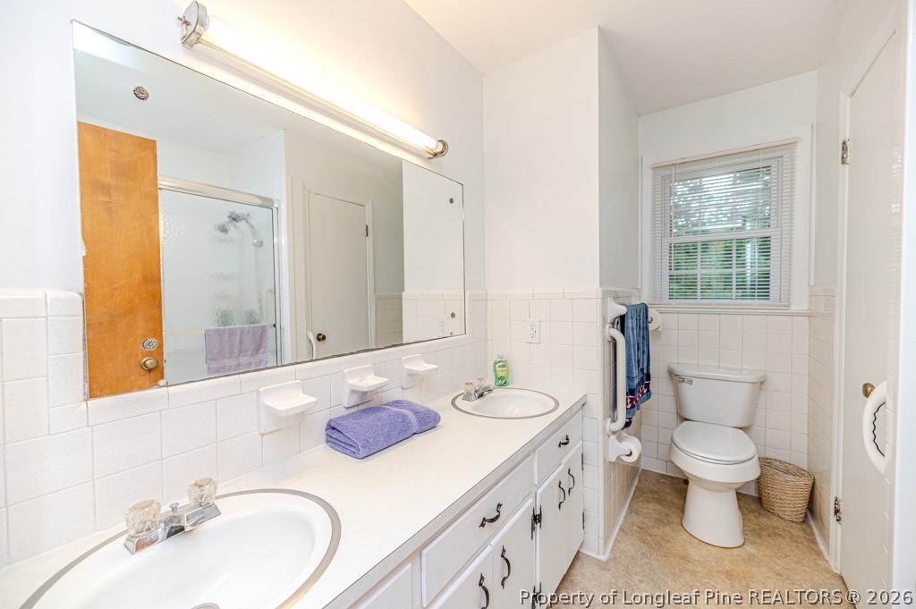 3384 Goldston Glendon Road Goldston, NC 27252 - Photo 25 of 47 a bathroom with a granite countertop toilet sink and mirror