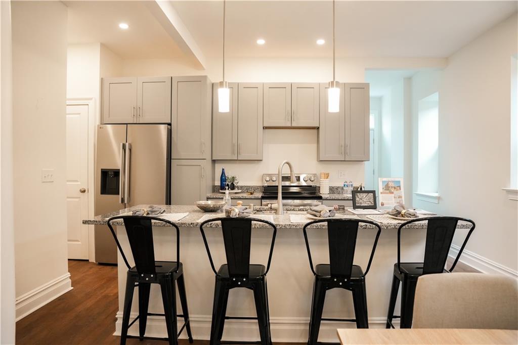 121 Shetland Street Pittsburgh, PA 15206 - Photo 15 of 37 a kitchen with stainless steel appliances granite countertop a dining table chairs and white cabinets
