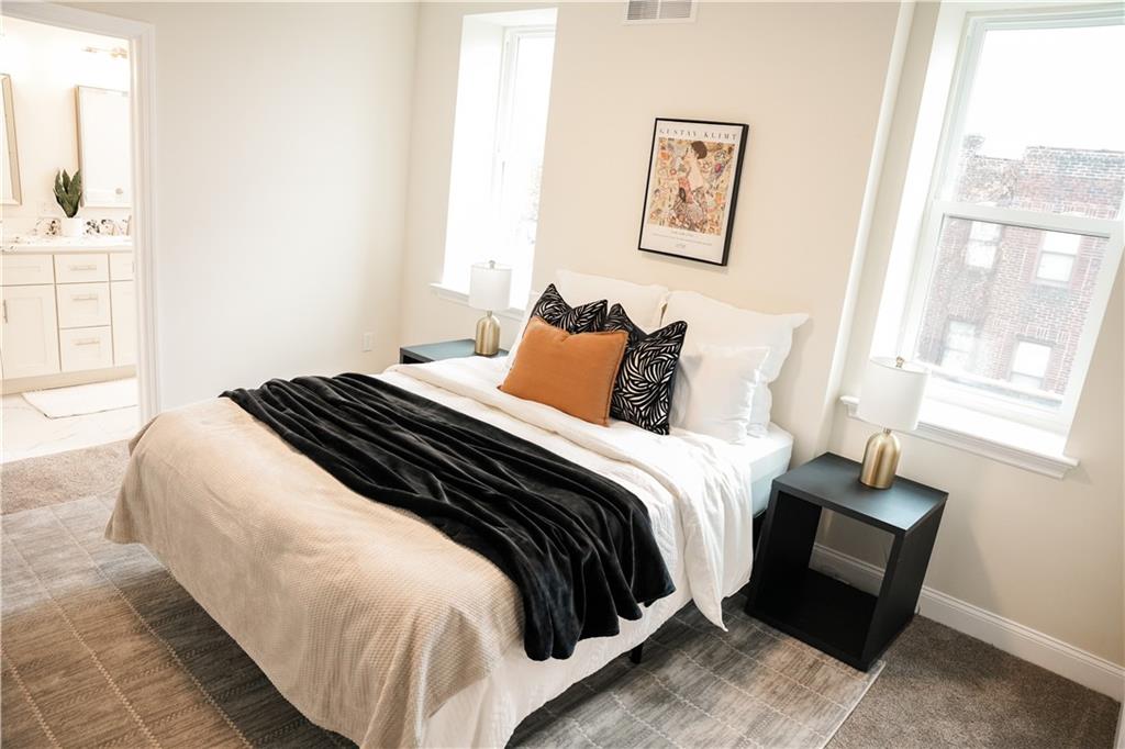 121 Shetland Street Pittsburgh, PA 15206 - Photo 21 of 37 a bedroom with a bed and wooden floor