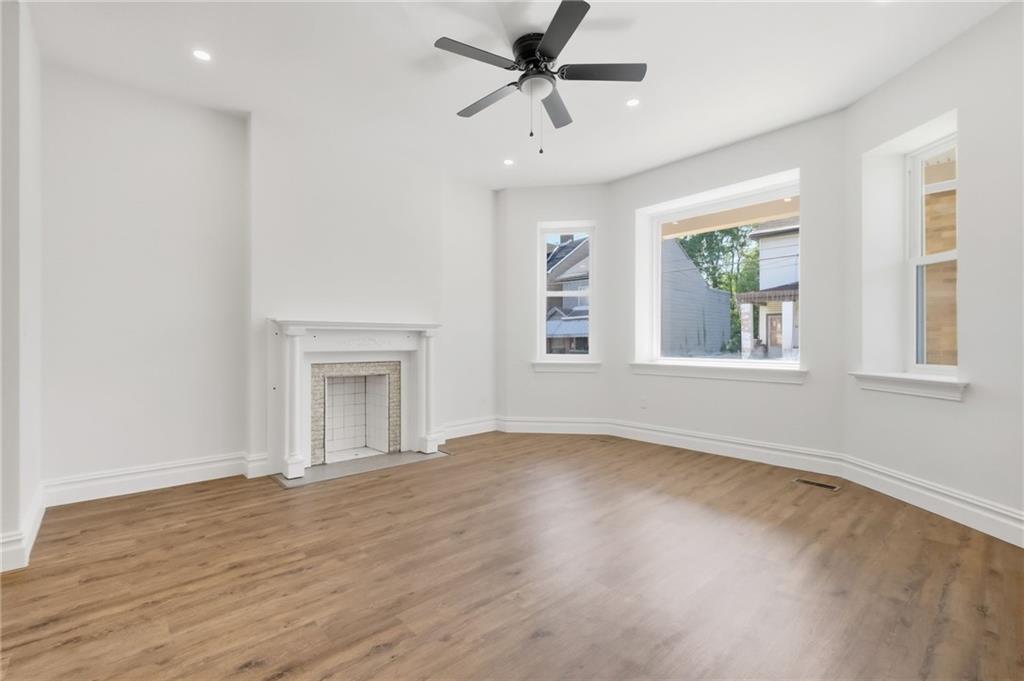 121 Shetland Street Pittsburgh, PA 15206 - Photo 6 of 37 a view of an empty room with a window and wooden floor