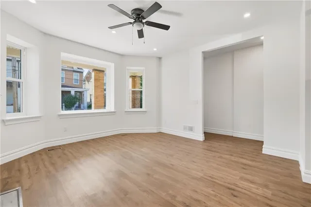 wooden floor in an empty room with a window