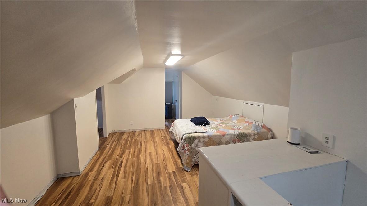 13232 Sperry Road Chesterland, OH 44026 - Photo 9 of 18 Bedroom featuring light wood-style floors and lofted ceiling