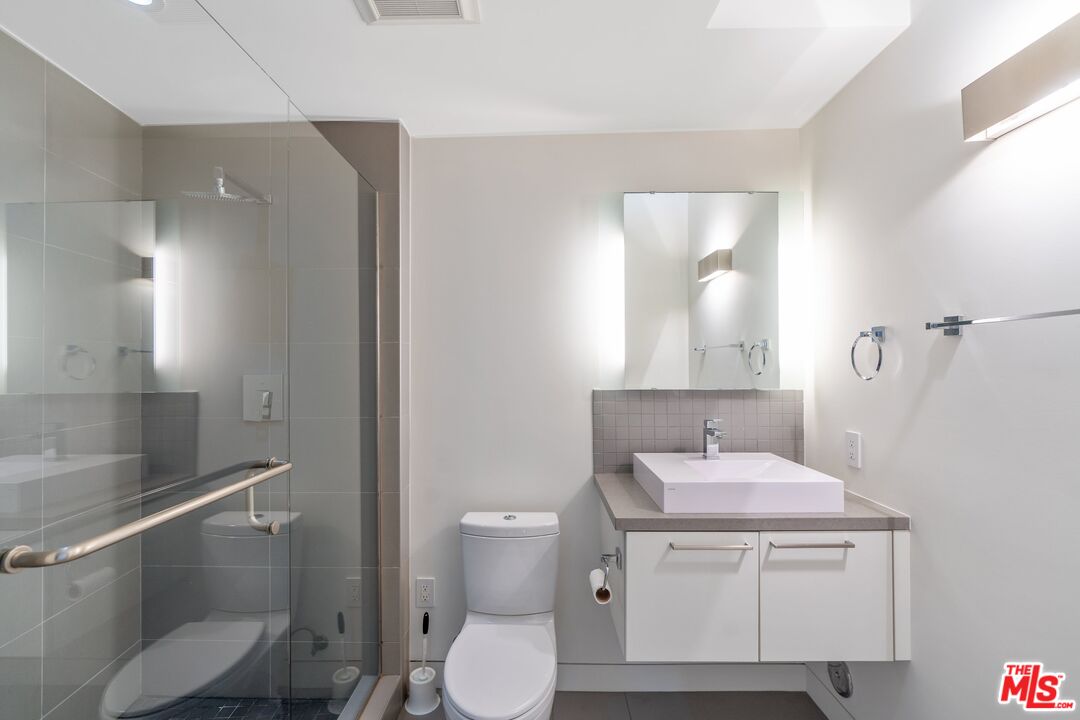 351 Sunset Avenue, Unit 1 Venice, CA 90291 - Photo 17 of 25 a bathroom with a sink toilet and vanity