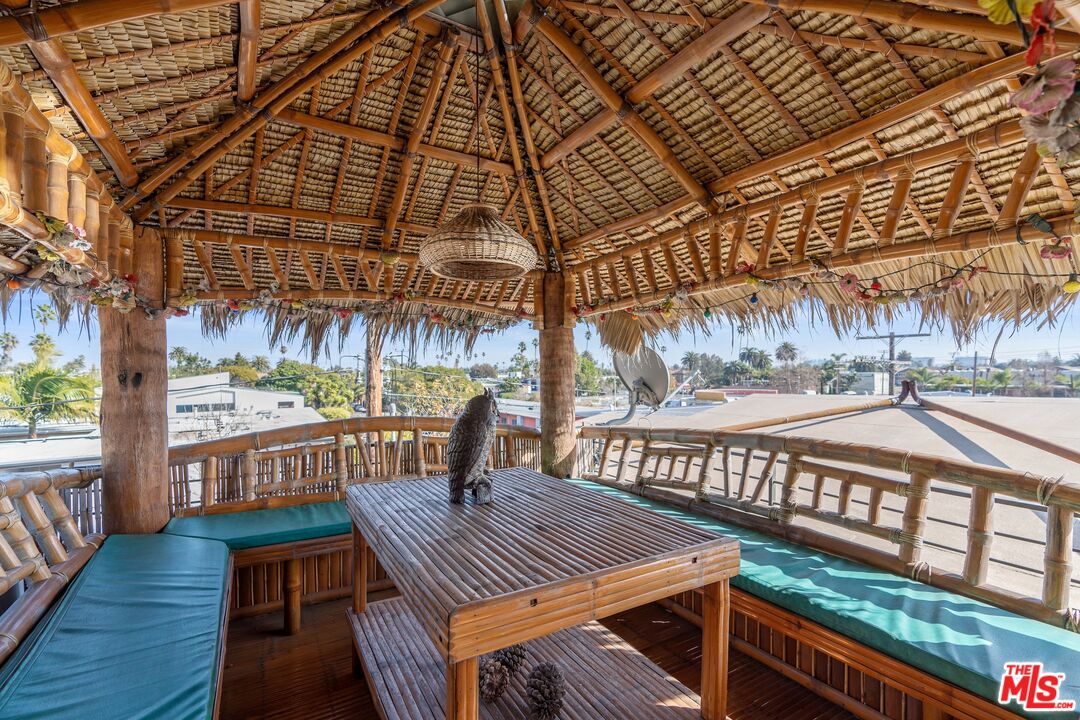 351 Sunset Avenue, Unit 1 Venice, CA 90291 - Photo 20 of 25 a view of a patio with table and chairs a barbeque with wooden floor and fence