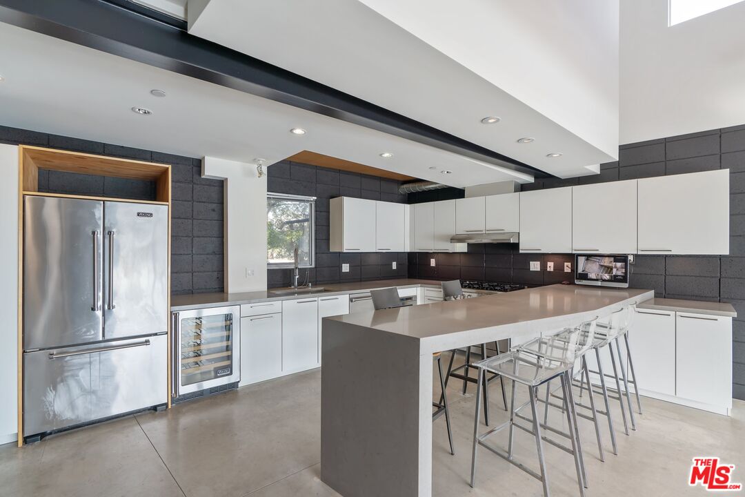 351 Sunset Avenue, Unit 1 Venice, CA 90291 - Photo 10 of 25 a kitchen with stainless steel appliances a refrigerator a stove a sink and white cabinets