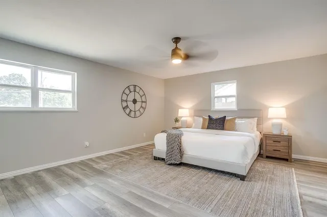 a spacious bedroom with a bed and a window