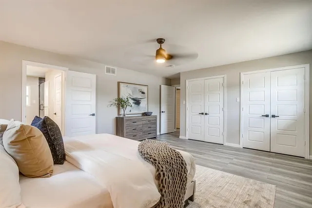 a bedroom with a bed and a chandelier