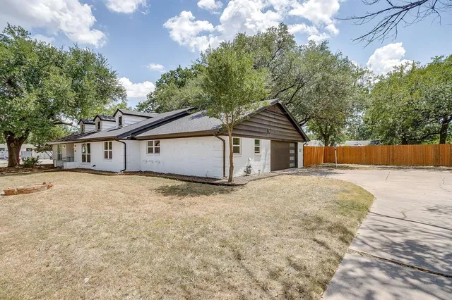 a front view of house with yard and trees