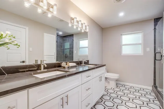 a bathroom with a sink a toilet and a mirror