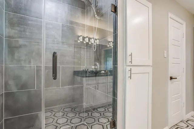 a bathroom with a glass shower door