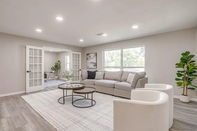 a living room with furniture and a potted plant