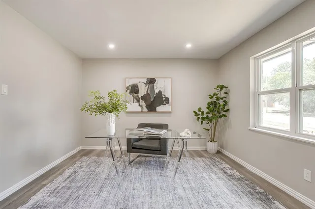 a workspace room with furniture and wooden floor