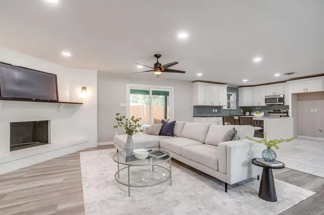 a living room with furniture a fireplace and a flat screen tv
